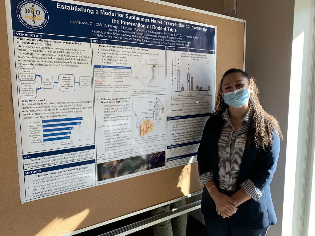 Student stands in front of her poster
