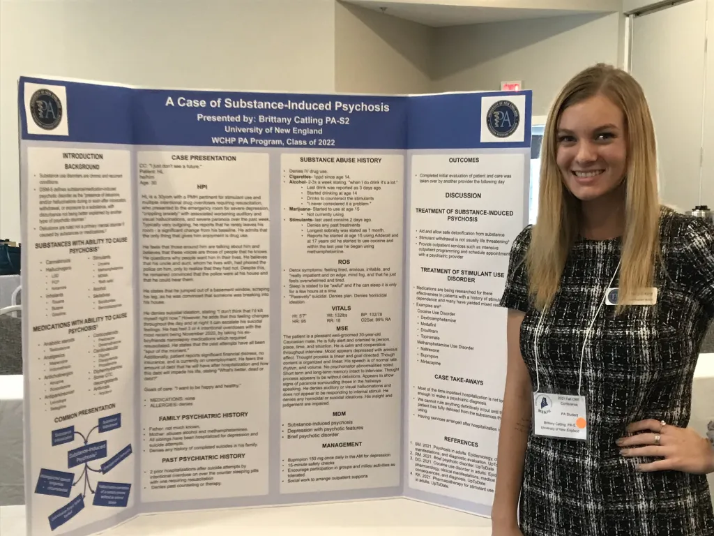 Brittany Catling stands next to her poster