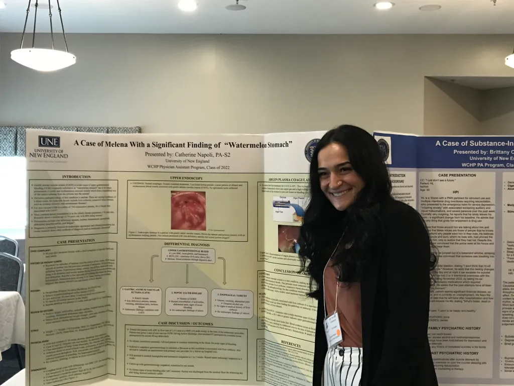 Catherine Napoli stands next to a poster
