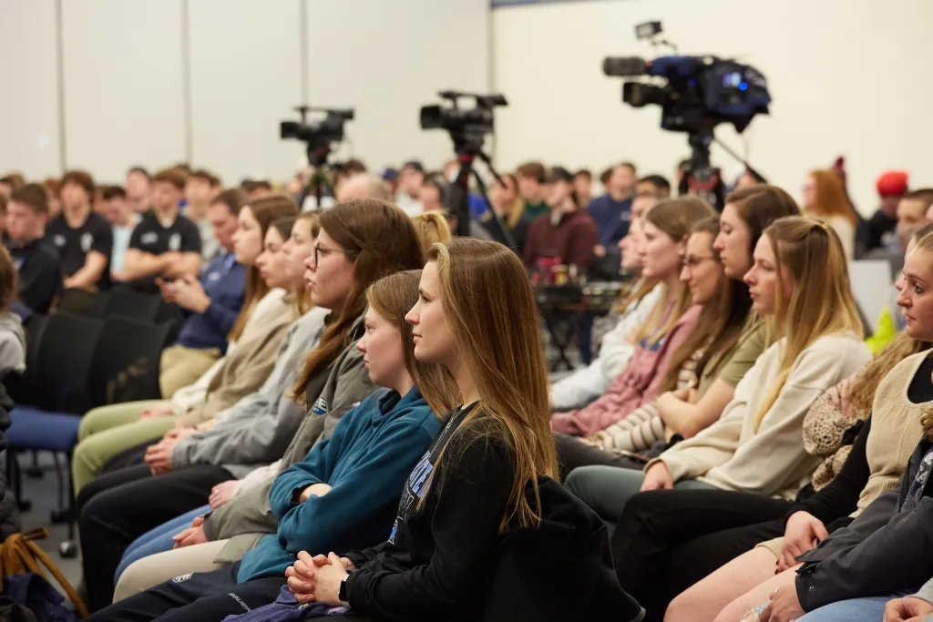 Students sit in the crowd
