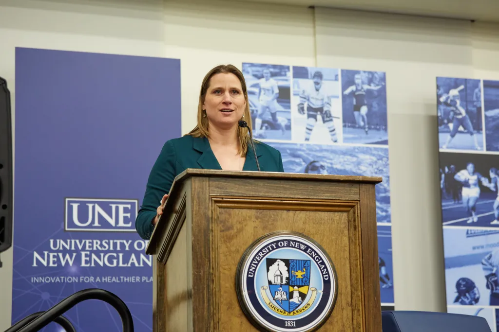 Angela Ruggiero stands at the podium