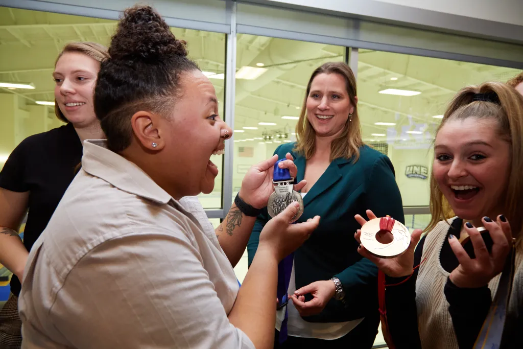Students hold Ruggiero's Olympic medals