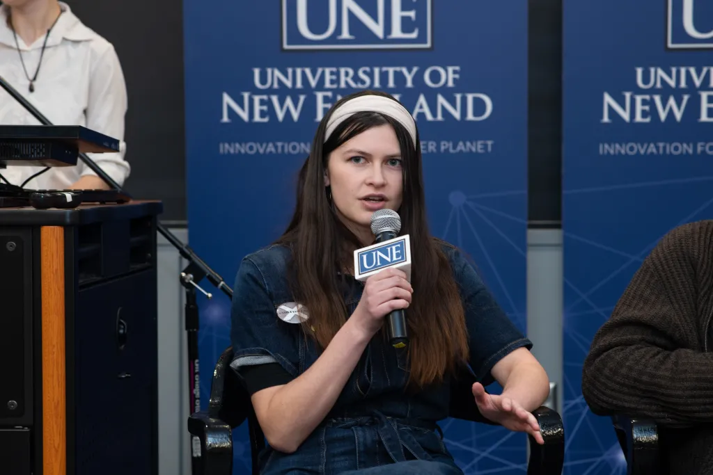UNE student Kiara Frischkorn speaks at a panel presentation.
