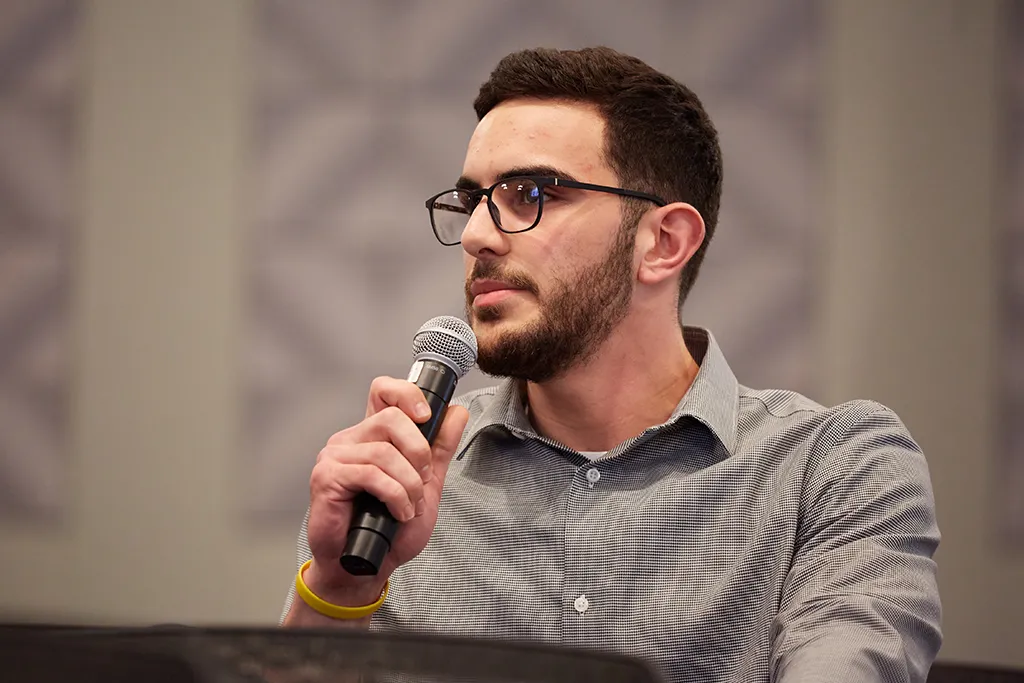 A student responding to a speaker at a lecture