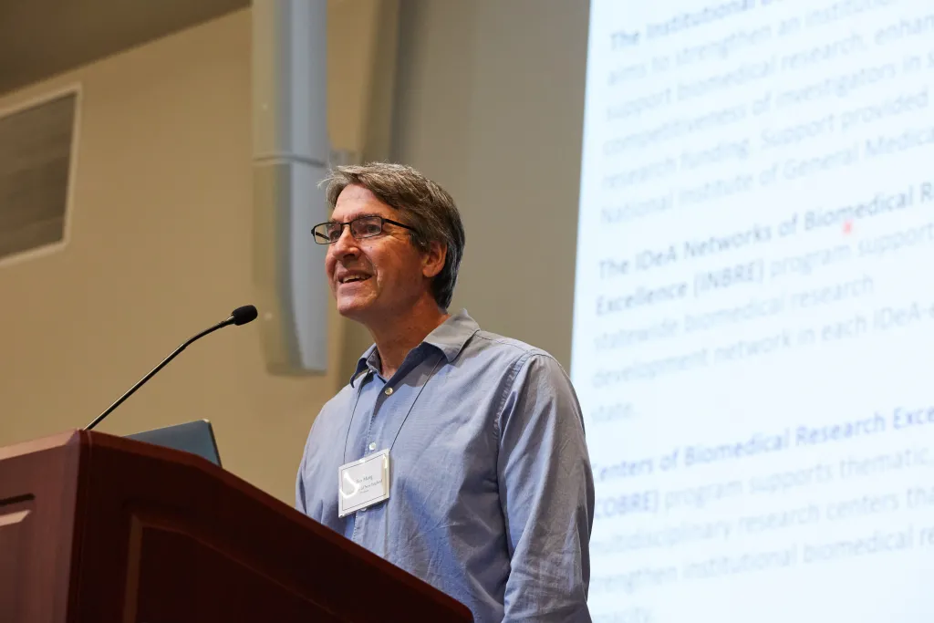 UNE's Ian Meng, Ph.D., speaks at the podium