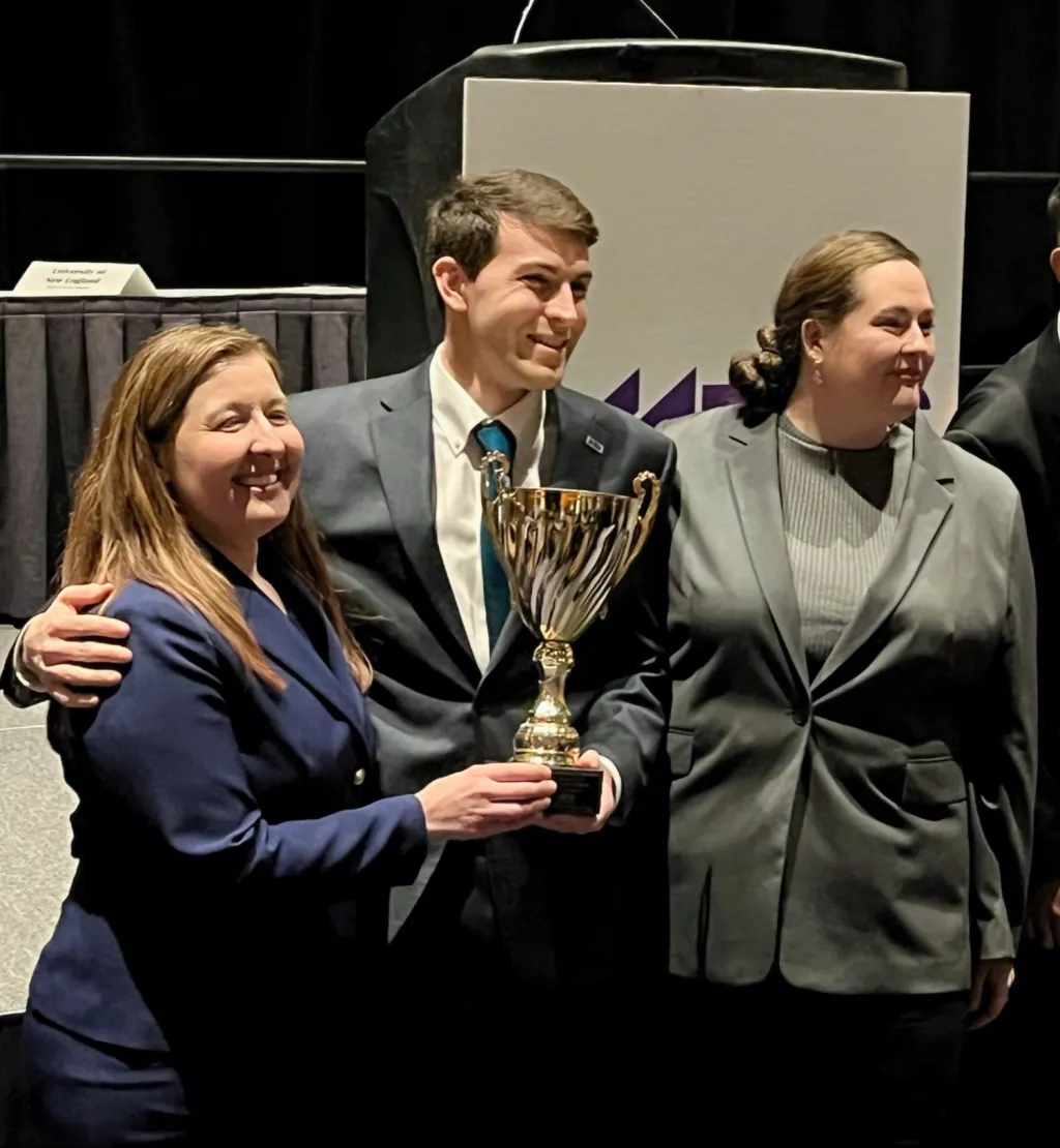 Dean Kimmes, Golden, and McDowell pose with a trophy
