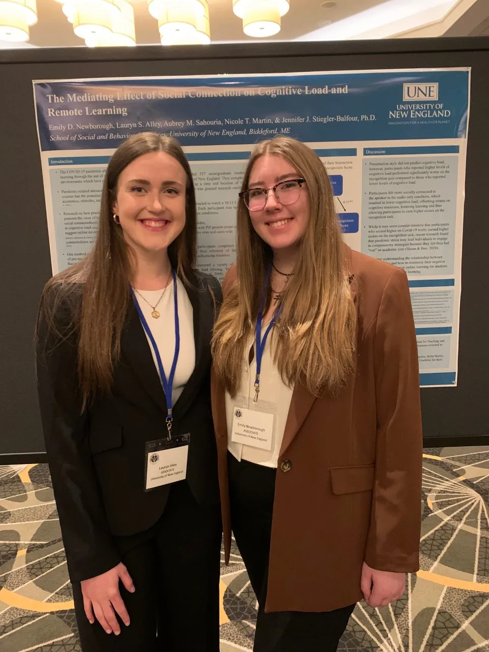 Lauryn Alley and Emily Newborough pose in front of their poster