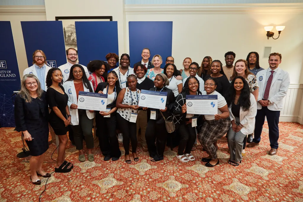 UNE and Cheyney officials and students gather for a group photo
