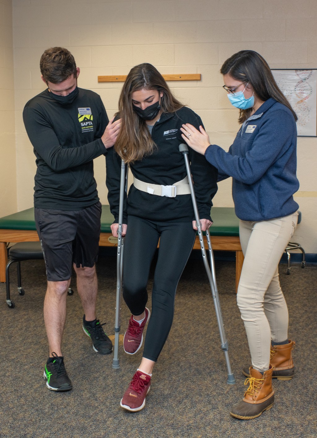 Two Physical Therapy students practice assisting a patient with new crutches
