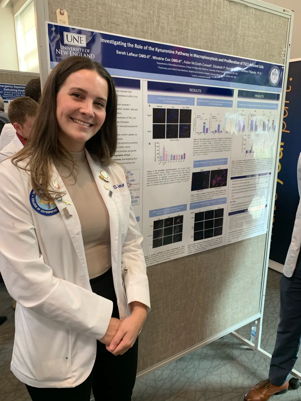 COM student Sarah Lafleur poses in front of her poster