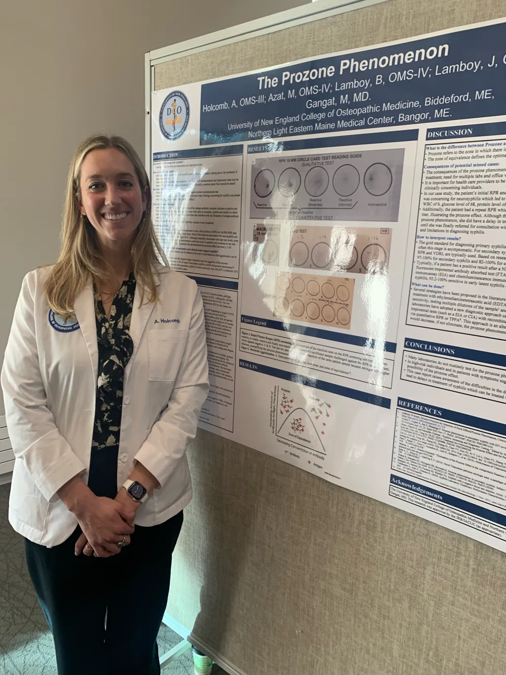Anna Holcomb poses in front of her poster