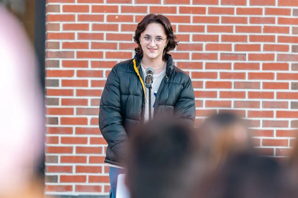 A student speaks at a candlelight vigil