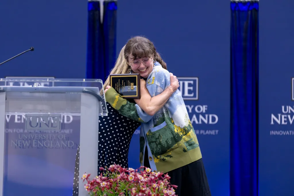 student hugging factually member University Awards 2024