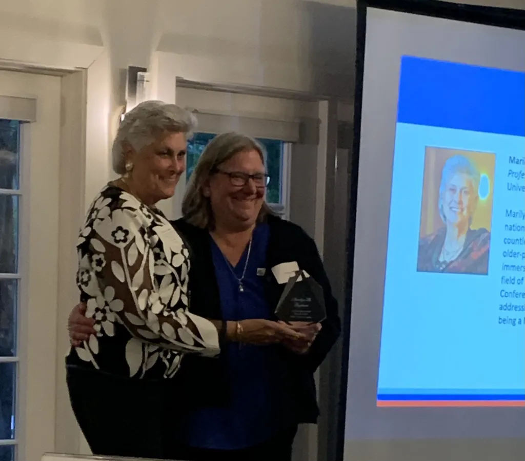 Marilyn Gugliucci of UNE accepts an award at a reception