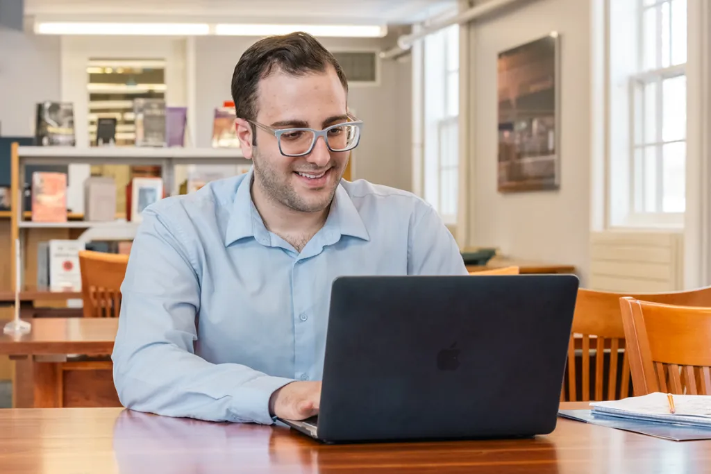 A student studies at their laptop