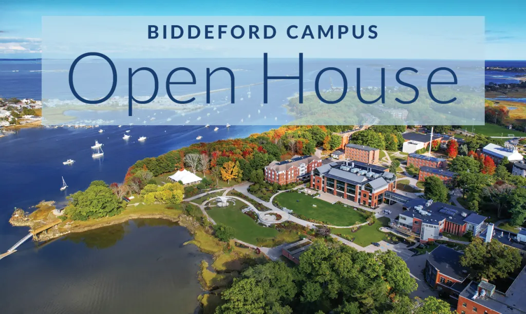 An aerial view of the Biddeford Campus including the brick buildings, coastline, and ocean.