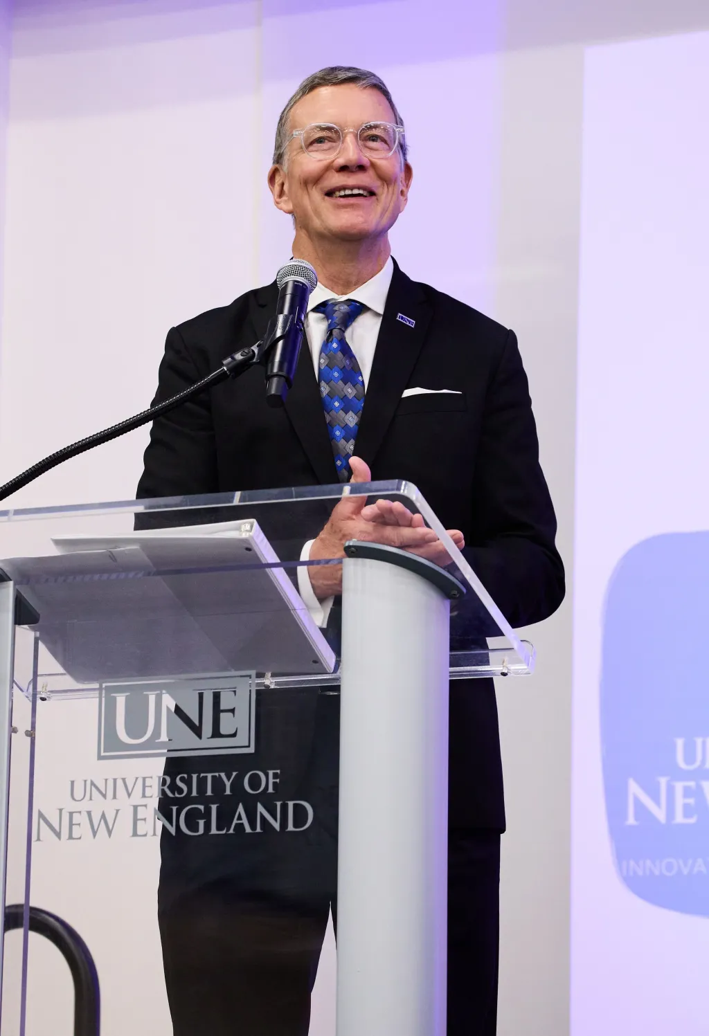 UNE President James Herbert speaks at the podium