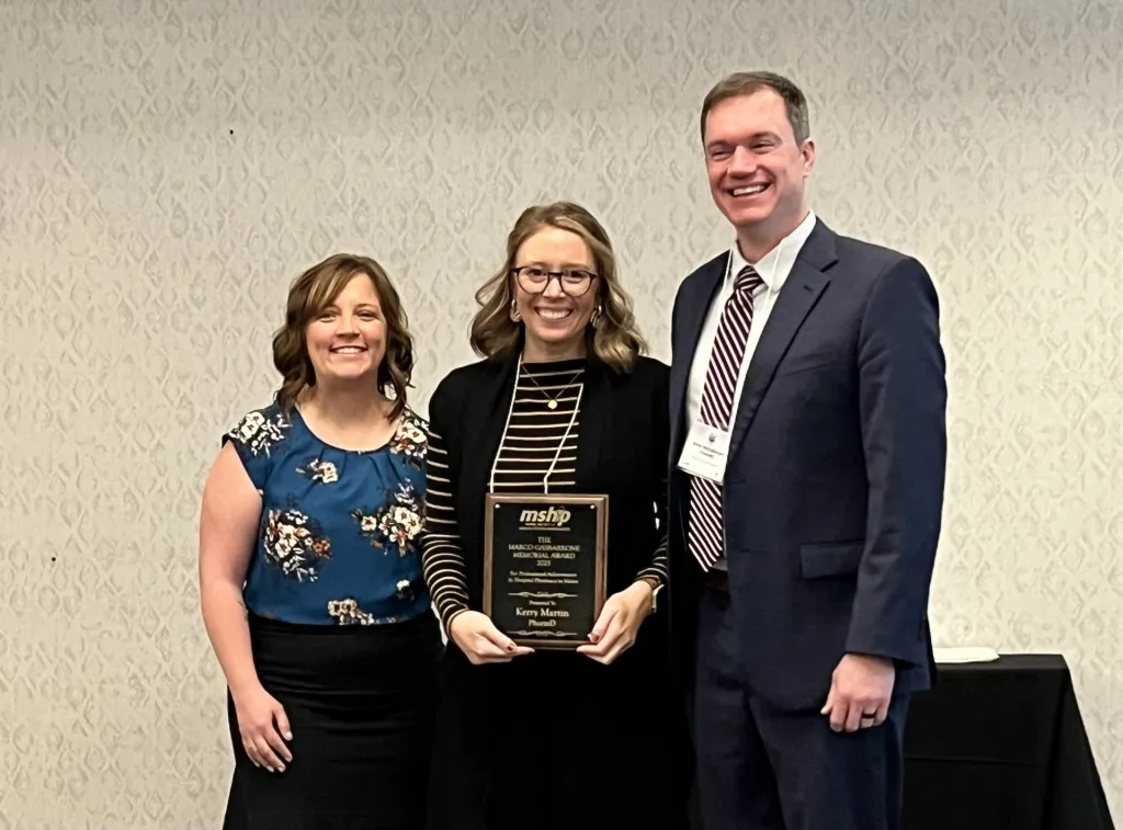 Kerry Martin, center, receives state award