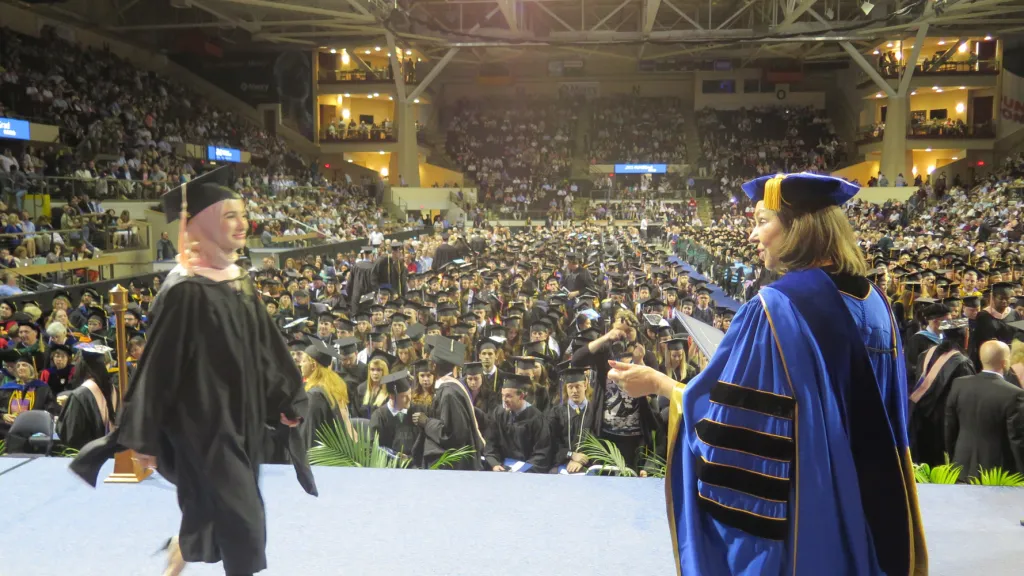 UNE President Danielle Ripich congratulates a graduate. Commencement 2017 was Ripich's last UNE Commencement before her retireme