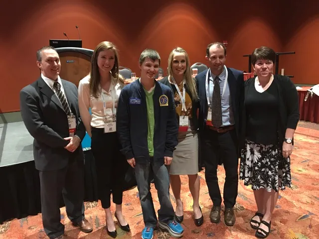 Taryne (Ela) Thomas (center) presented with interprofessional colleagues from MD Anderson Cancer Center