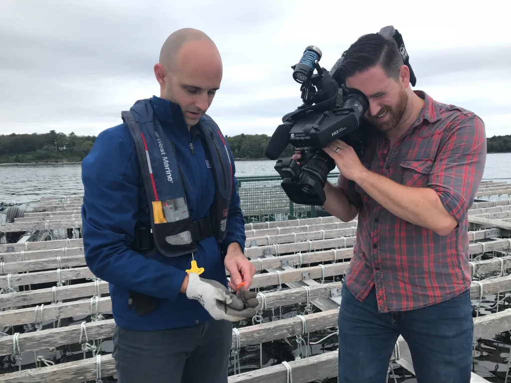 UNE assistant research scientist Adam St. Gelais shows off a muscle to NBC Boston videographer Ken Tompkins