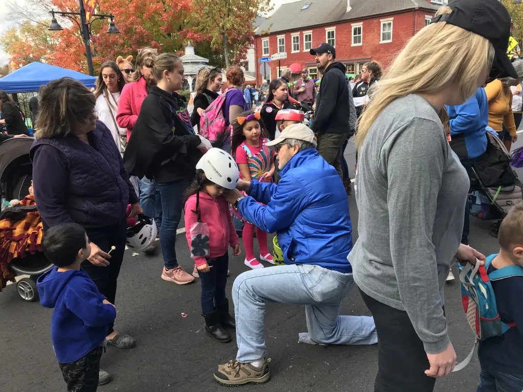 CEN volunteers helped fit children with helmets at the Saco Main Street Pumpkin Harvest Festival