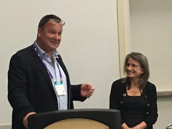 Jane Carreiro, D.O., is recognized by Osteopathic International Alliance board member Charles Hunt, D.O., for her leadership and