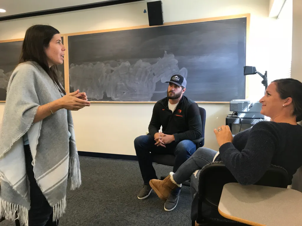 Aimee Vlachos chats with Josh Osich and his wife Jessica, a recent UNE graduate