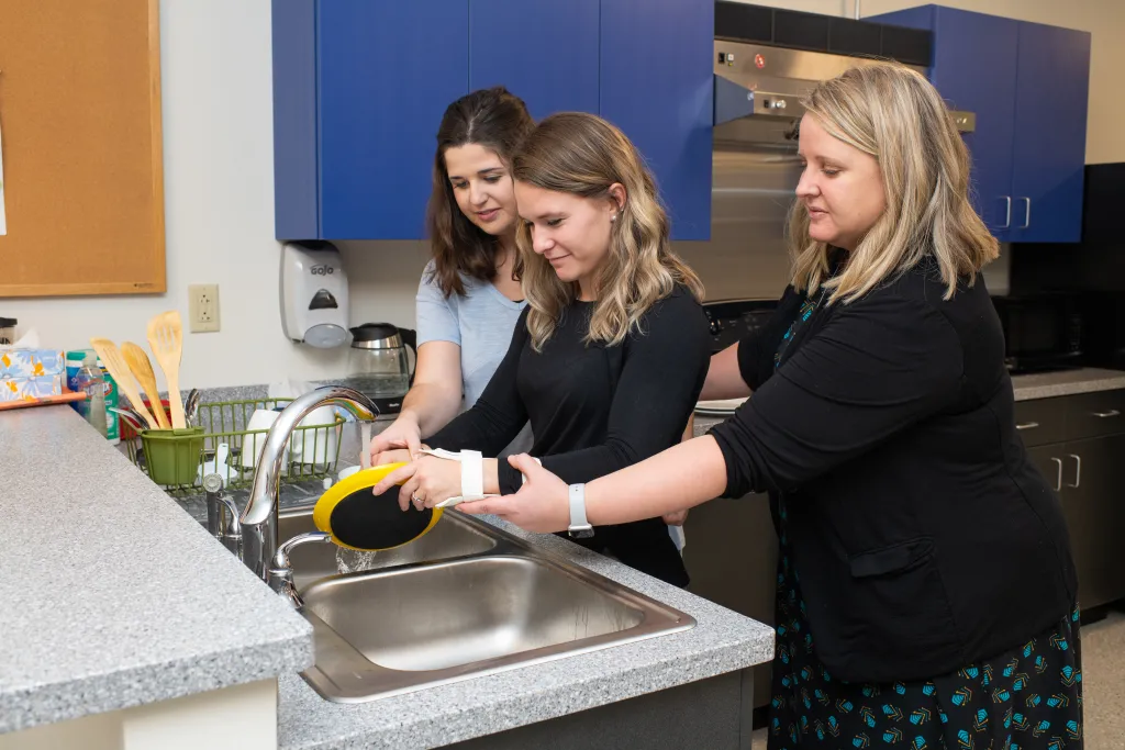 Students using sink in OT lab