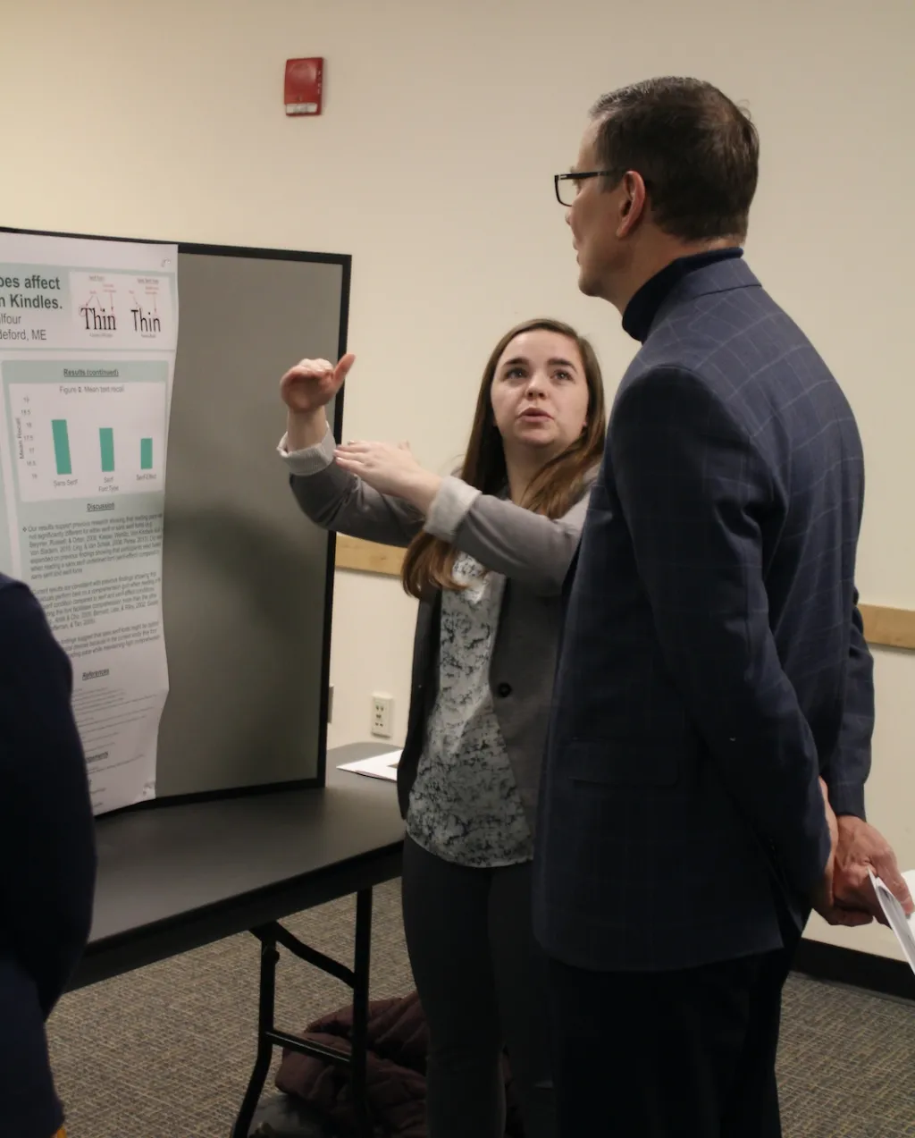 Ellie Leighton describes her research project to UNE President James Herbert