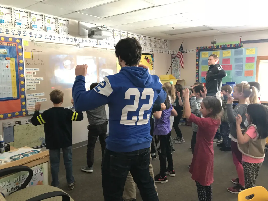 Students at the Eight Corners School get Jack Mahoney and Drew Patno moving to the "Chicken Dance" during a break from reading