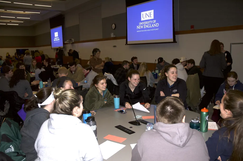 Small groups of students engaged in a robust discussion after the presentation