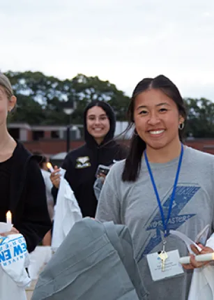Students smile as they move into their dorms