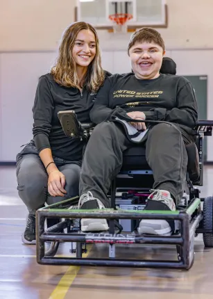 A UNE student poses with a Maine Adaptive client
