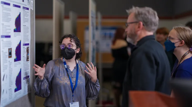 student presents to UNE alumni and faculty during homecoming and family weekend