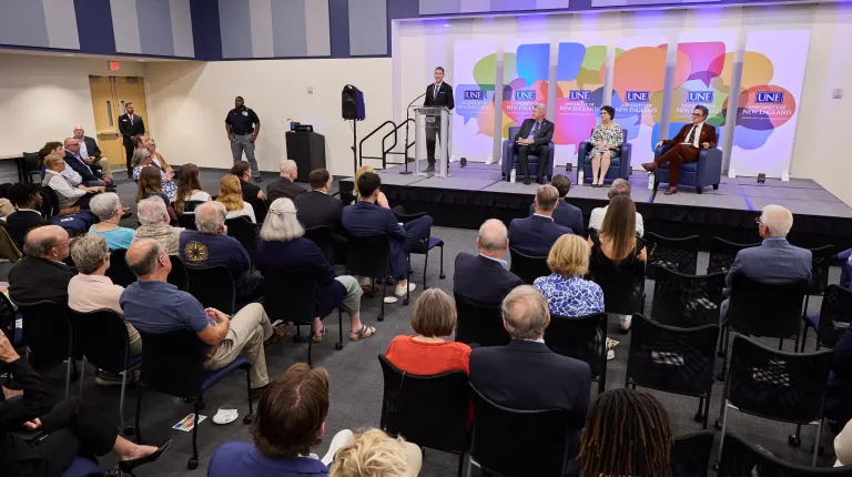 A crowd gathers in the Harold Alfond Forum for a panel discussion