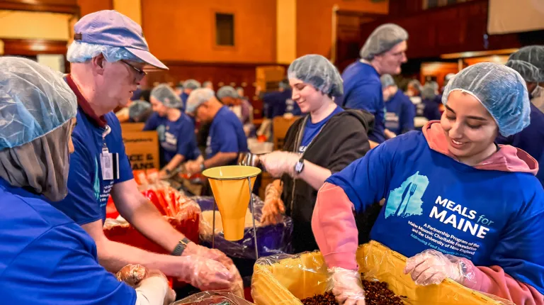 Since starting in 2023, UNE’s large-scale, meal-packaging effort had produced 300,000 meals for individuals and families throughout the state; Wednesday’s event brought that number to 350,000. The Masonic foundation joined the effort last fall to help the program reach all 16 counties in Maine for the first time.  UNE Service Learning Director Trisha Mason said in her opening remarks that the Meals for Maine partnership with the Masons typifies UNE’s experiential-learning approach to education by providing 