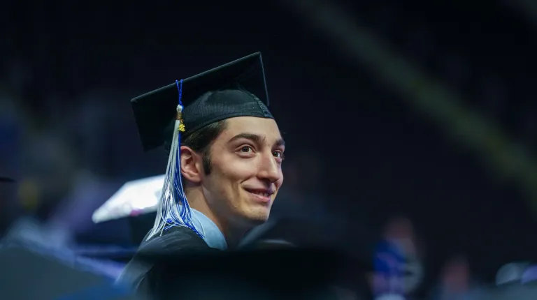 A student candid from UNE's 2026 Commencement