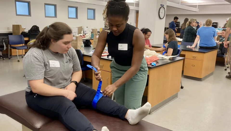 UNE students learn splints at a training station.
