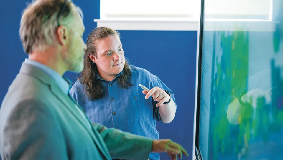 Ruth Ellis (Environmental Science, ’25) discusses environmental and public health data visualizations with Cameron Wake in the P.D. Merrill Makerspace