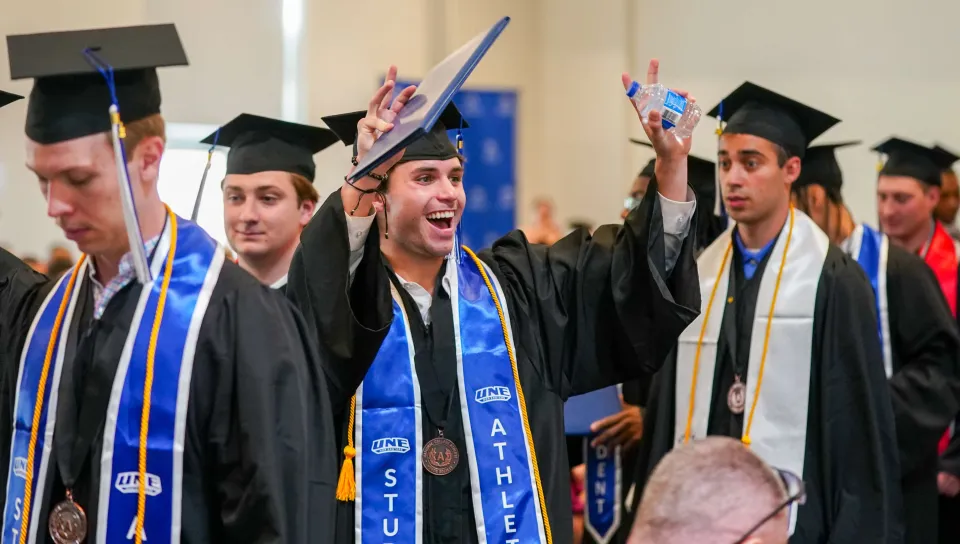 Students celebrate earning their diplomas at UNE's 2026 Commencement