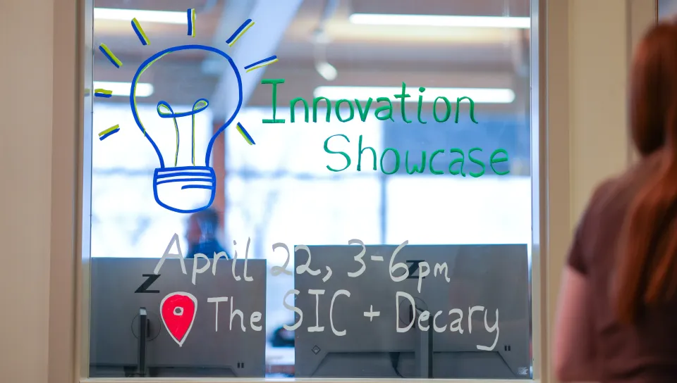 Window paint reads "Innovation Showcase" with the date, location, and drawing of a lightbulb included