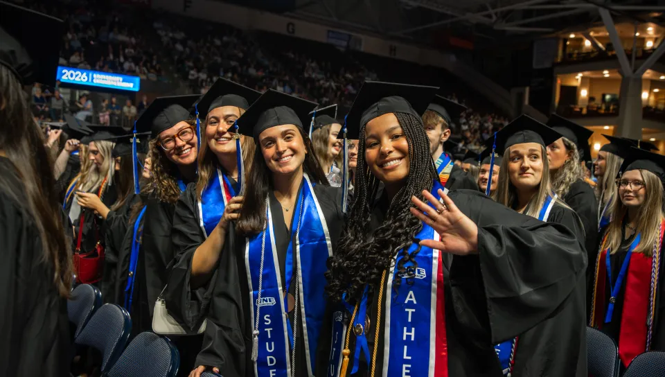 Students post for a group photo at UNE's 2026 Commencement