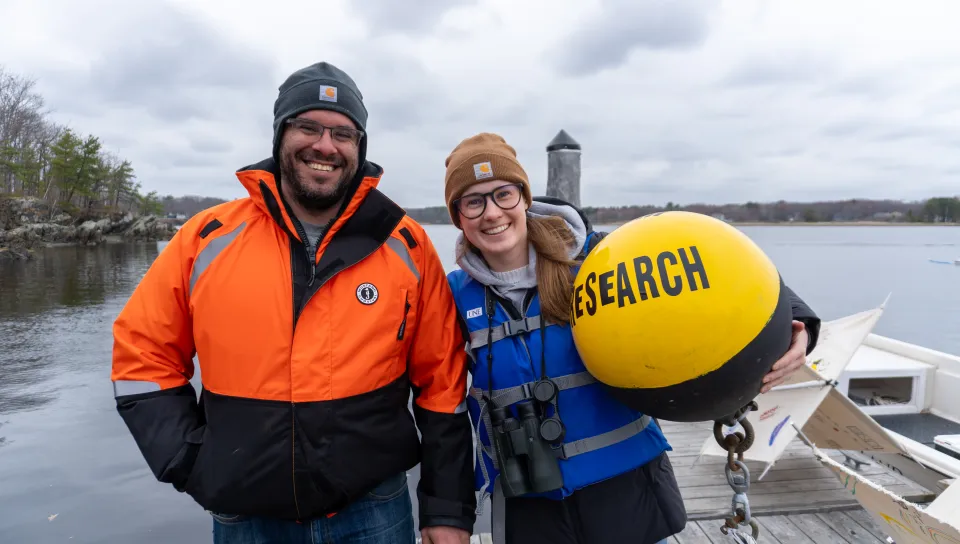 Johanna Birchem poses with a startup founder after deploying a new research buoy