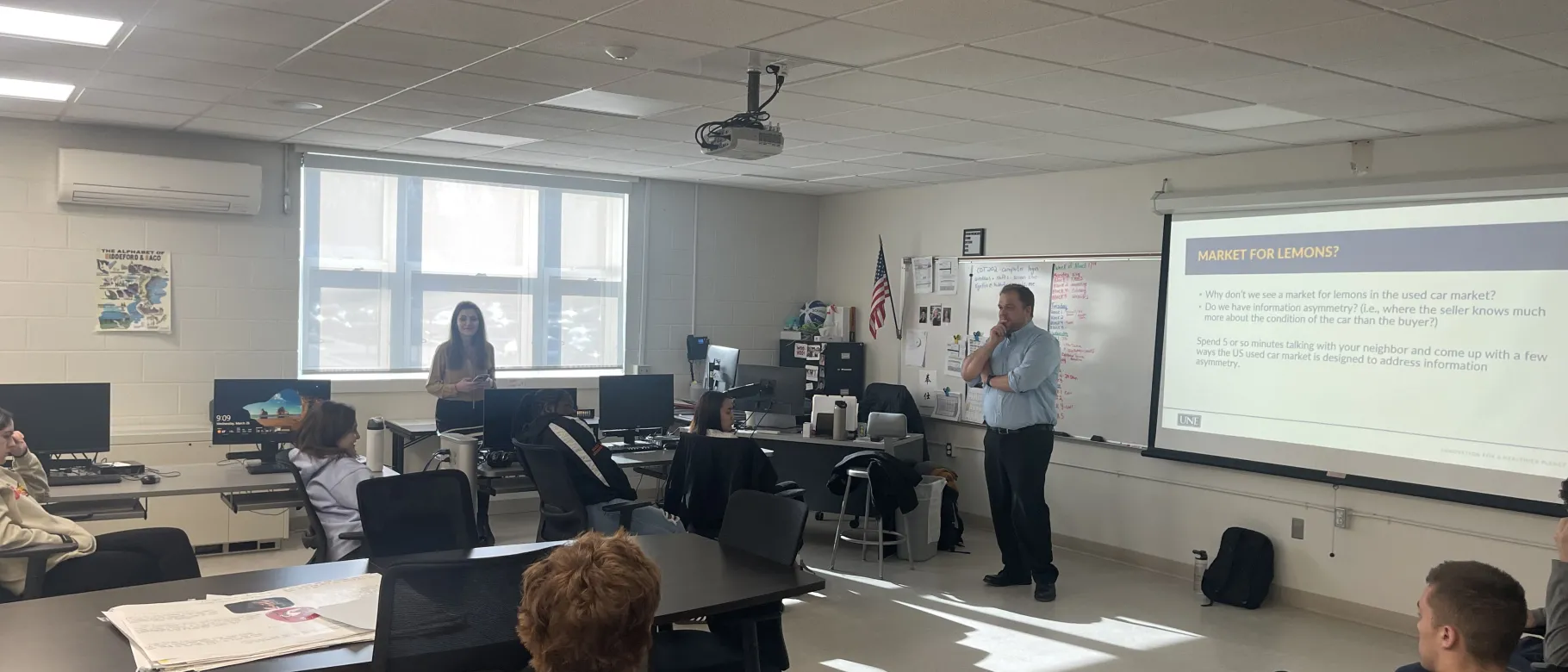 UNE's Tim Potsaid presents a slideshow to a group of high school students