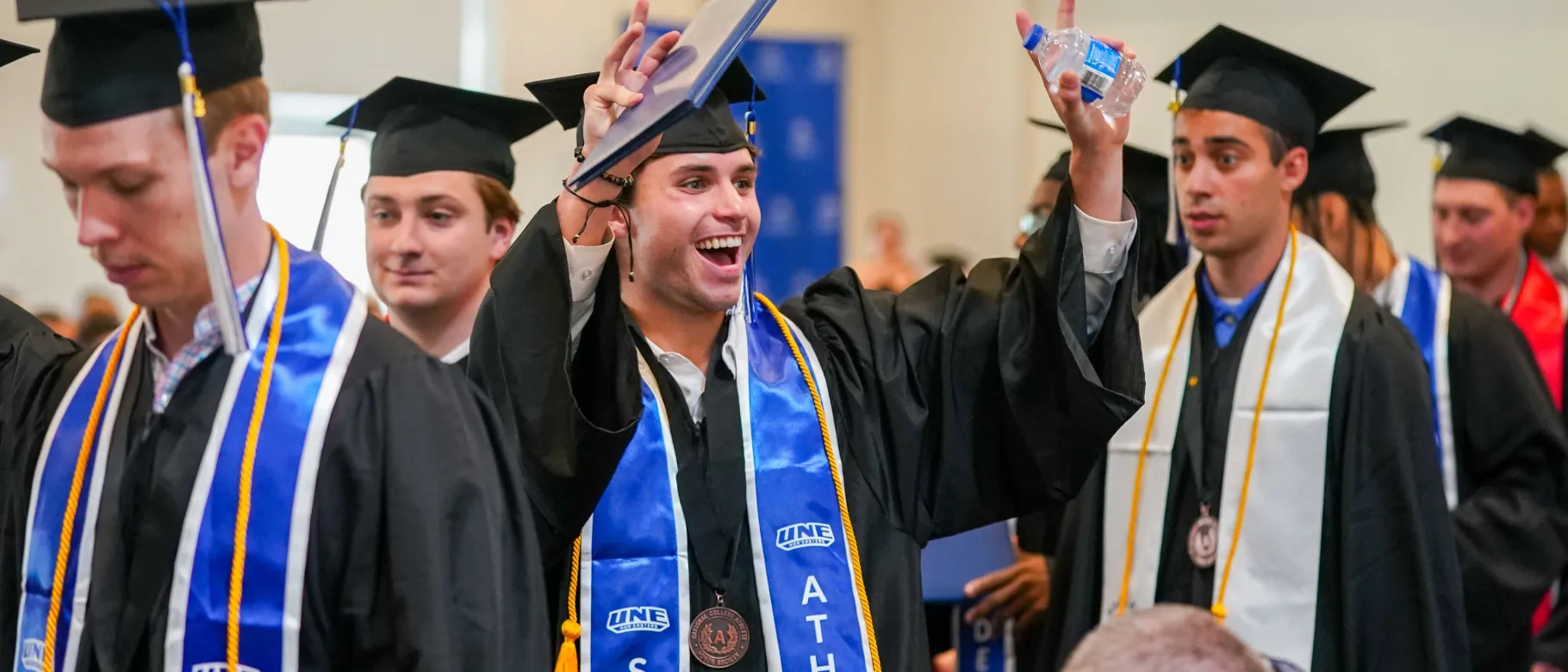 Students celebrate earning their diplomas at UNE's 2026 Commencement