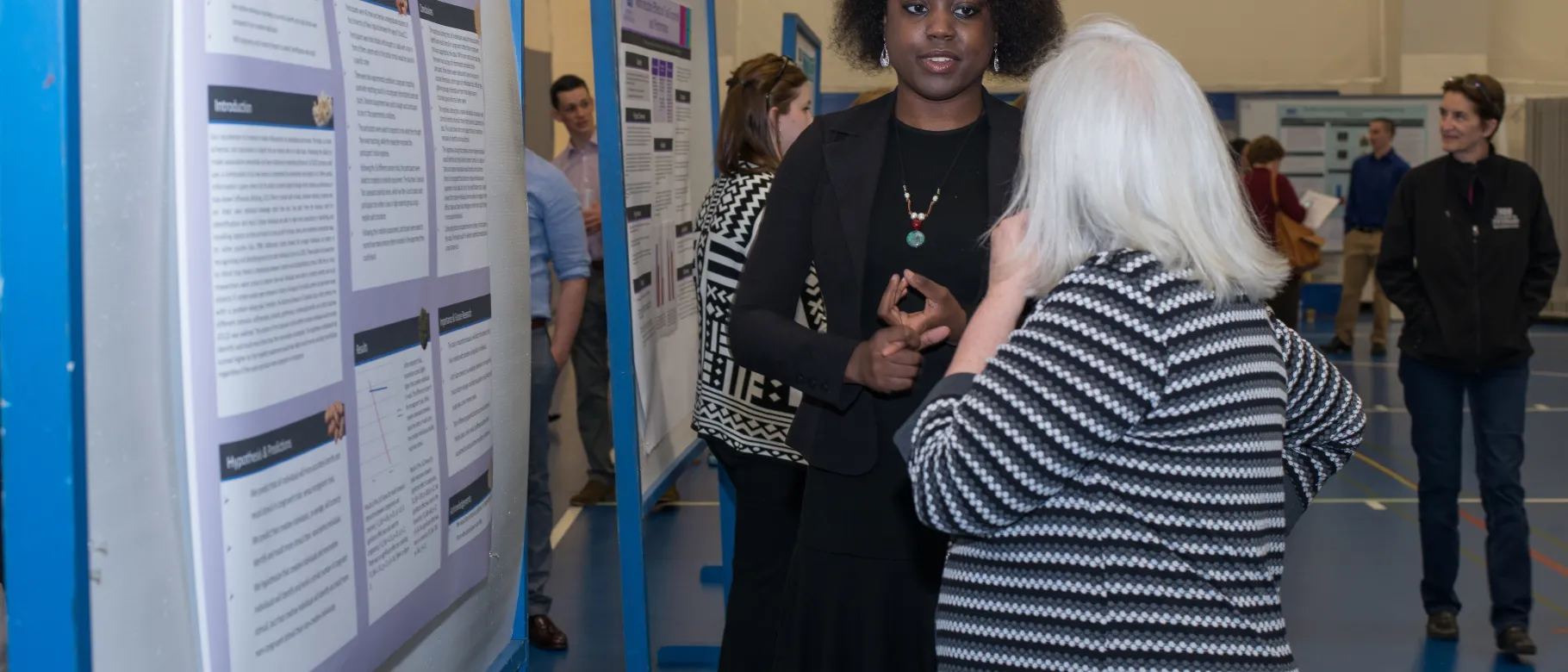 Student researcher Amanda Anderson explains her poster.