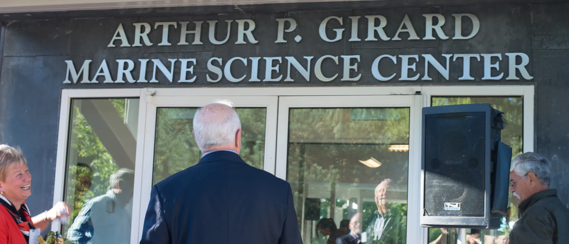 Arthur Girard looks up as the center's new name is revealed