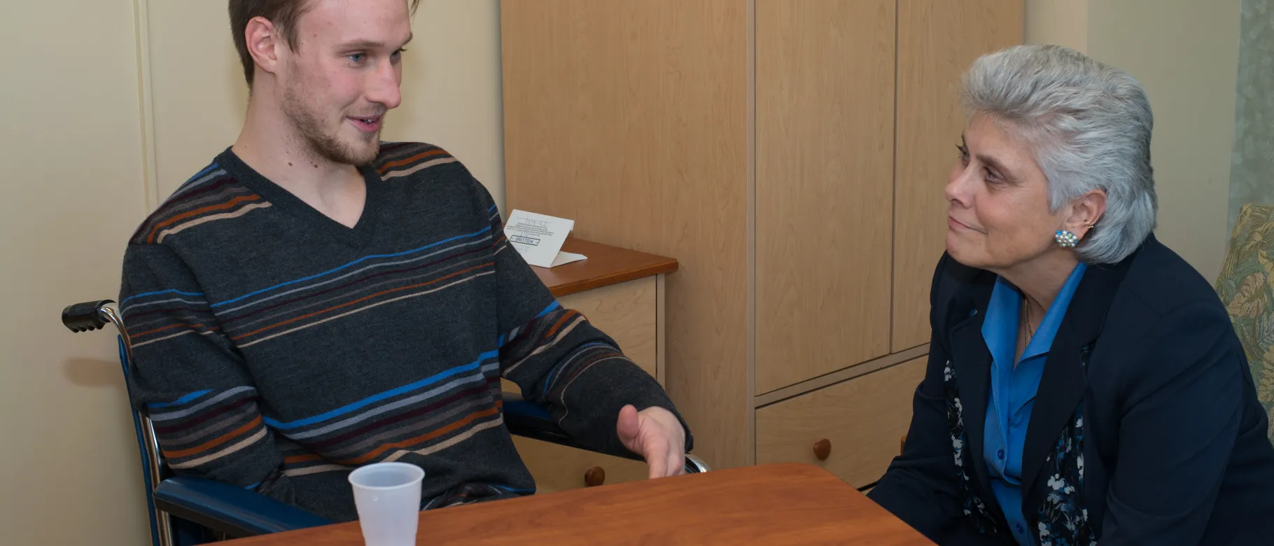 Marilyn Gugilucci works with UNE COM student in the Learning by Living program