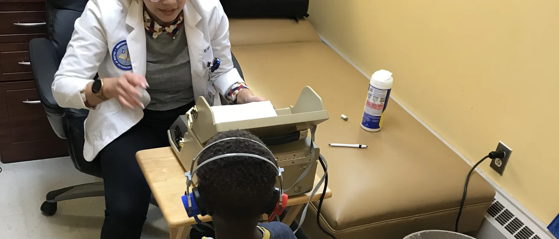 Fides Elamparo (D.O., ’22) performs hearing screenings at the Biddeford Primary School.